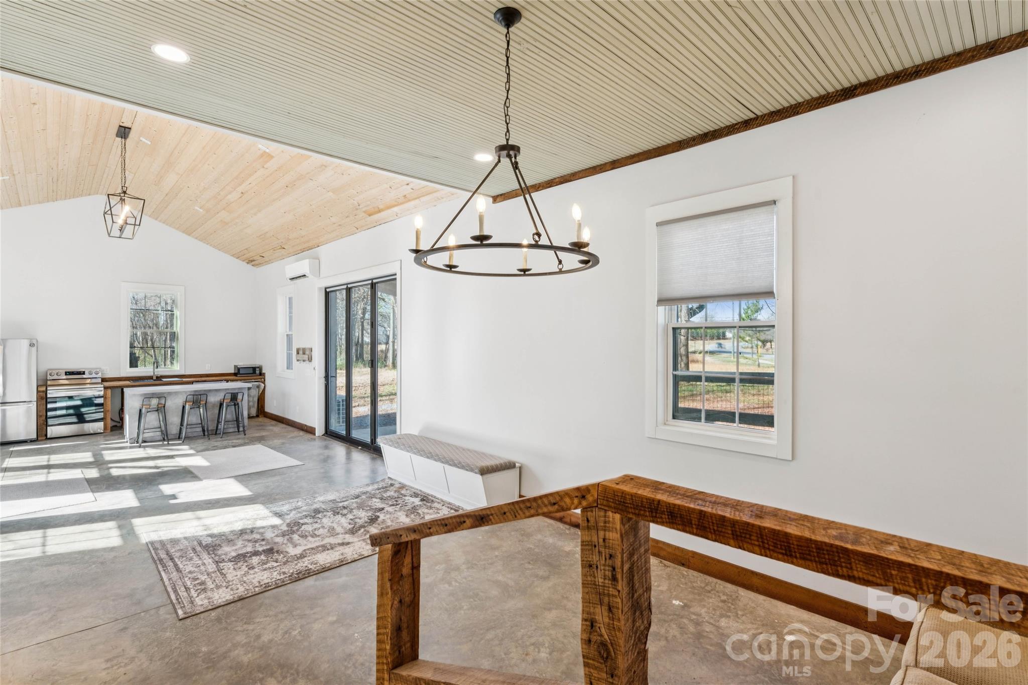 10799 Poplar Tent Road Huntersville, NC 28078 - Photo 9 of 46 a very nice looking room with a chandelier furniture and windows