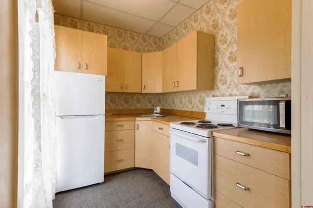 a kitchen with a stove a sink and a refrigerator