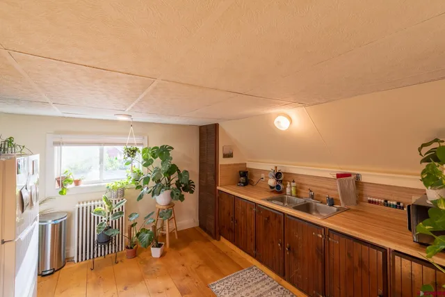 a living room with furniture a chandelier and a dining table