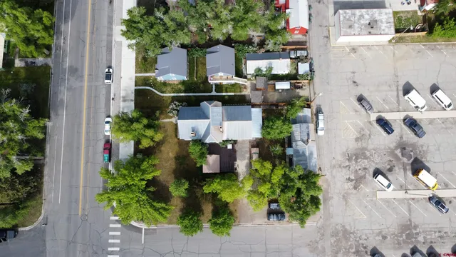 an aerial view of a house with a yard