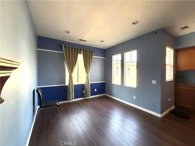 a view of room with hardwood floor and windows