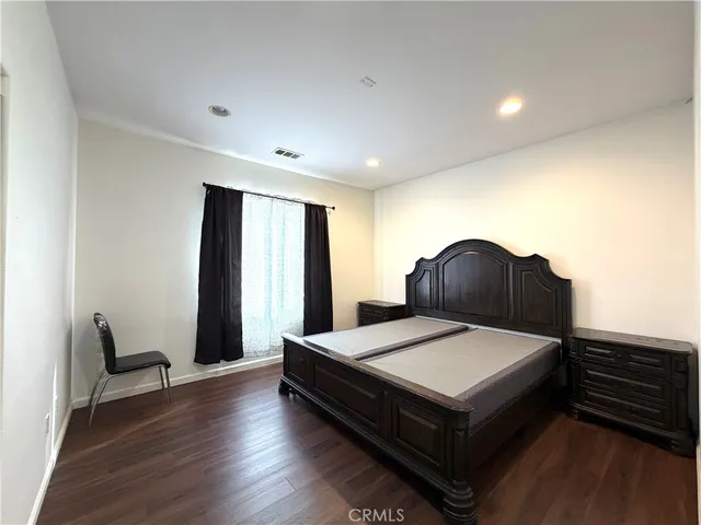 a bedroom with a bed and a chair