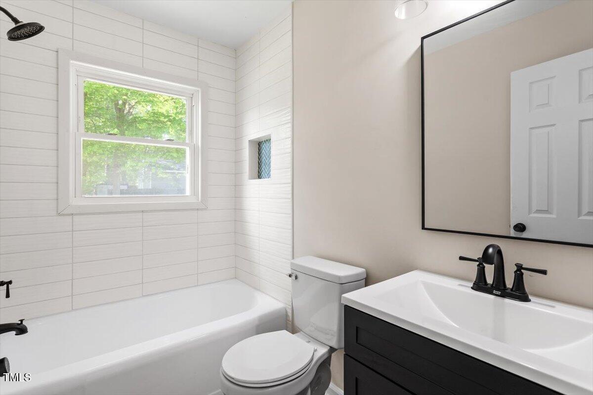 2304 Nelson Street Raleigh, NC 27610 - Photo 23 of 23 a bathroom with a sink toilet vanity and bathtub
