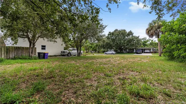 a white house in middle of the forest