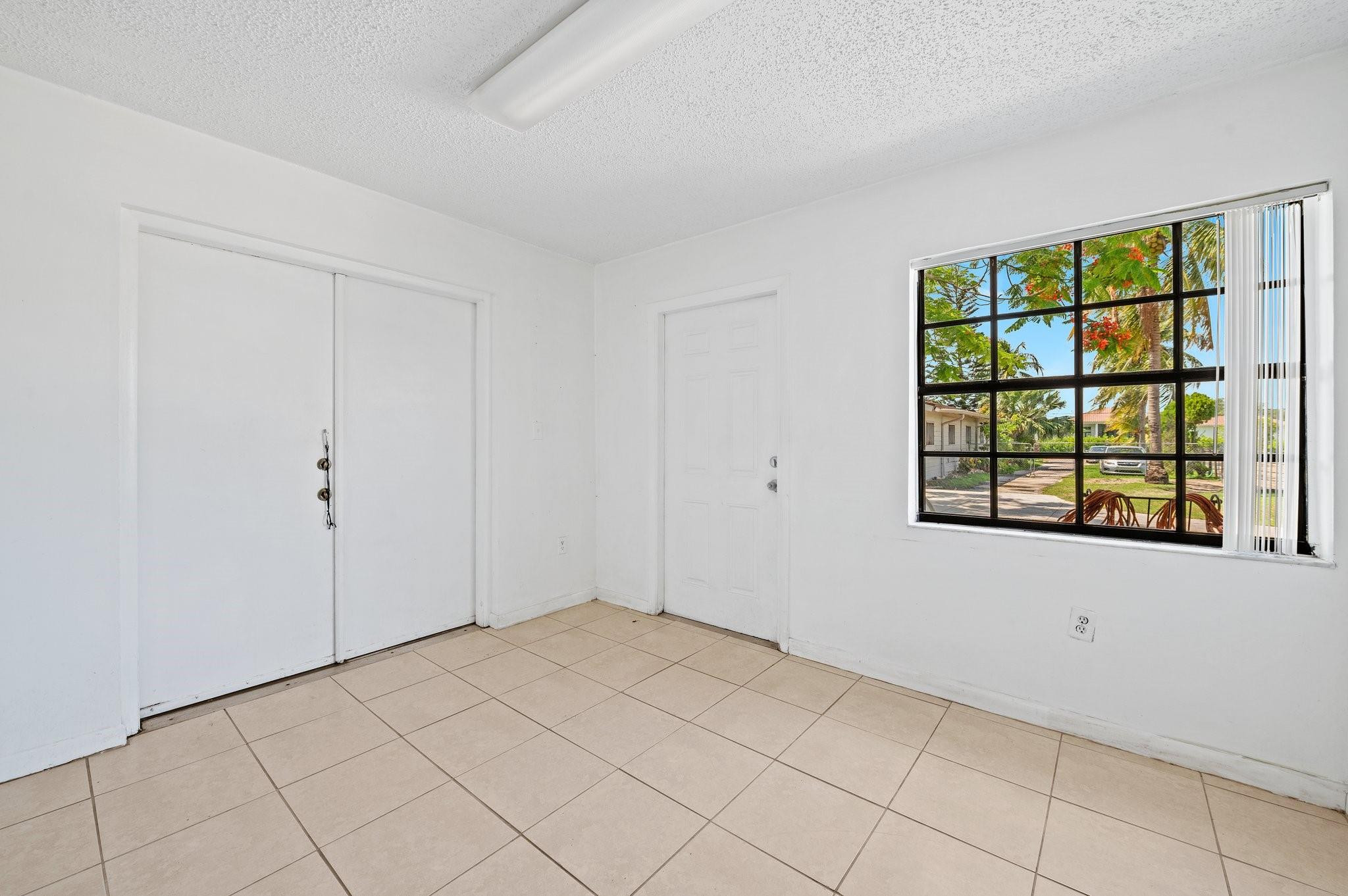 17640 Southwest 52nd Court Southwest Ranches, FL 33331 - Photo 70 of 90 FRONT ROOM WITH DOOR TO SIDE FENCED AREA