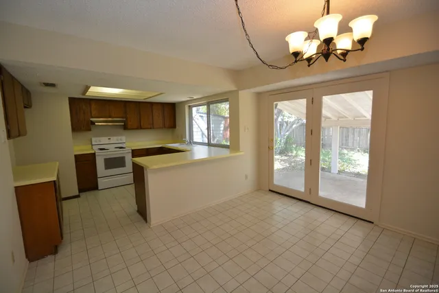 a kitchen with a stove a refrigerator and a sink