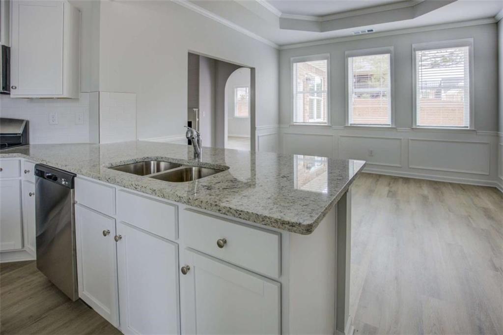 1007 Towne Circle Social Circle, GA 30025 - Photo 20 of 38 a kitchen with granite countertop a sink and a granite counter tops