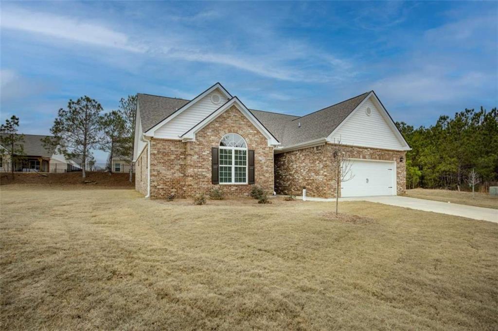 1007 Towne Circle Social Circle, GA 30025 - Photo 2 of 38 a front view of a house with a yard and garage