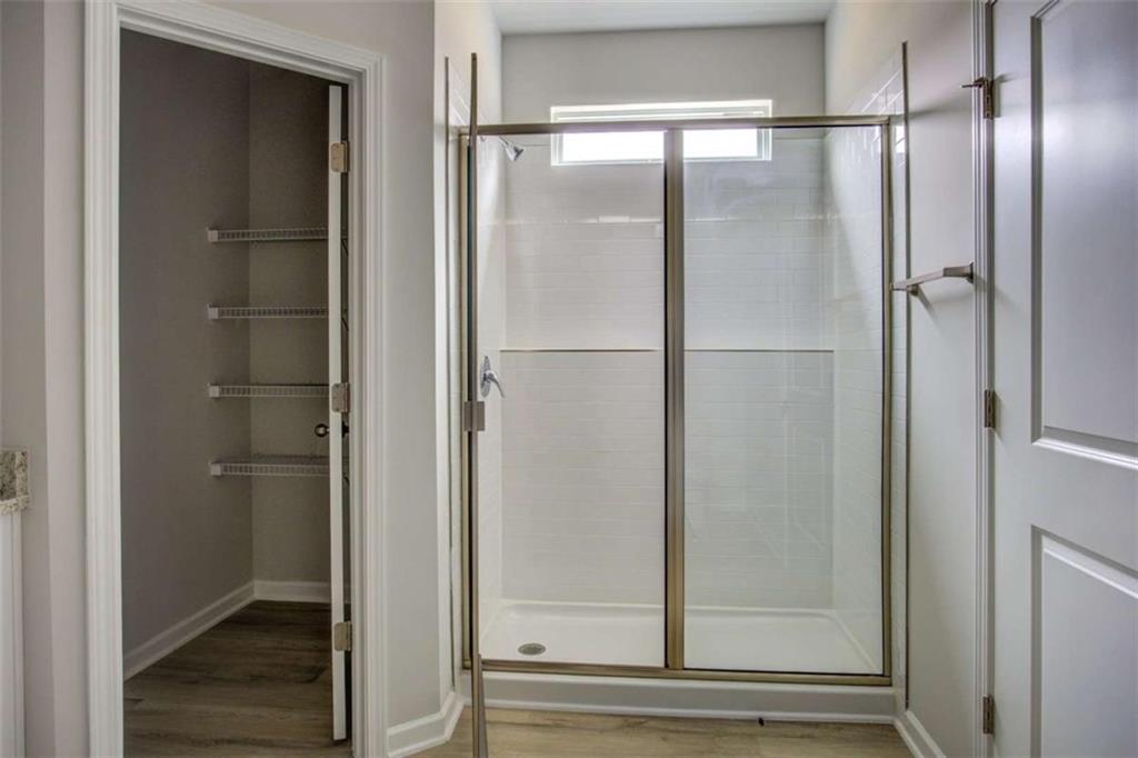 1007 Towne Circle Social Circle, GA 30025 - Photo 29 of 38 a bathroom with a glass shower door
