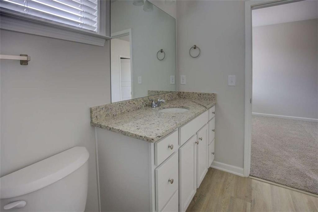 1007 Towne Circle Social Circle, GA 30025 - Photo 36 of 38 a bathroom with a granite countertop sink and a mirror