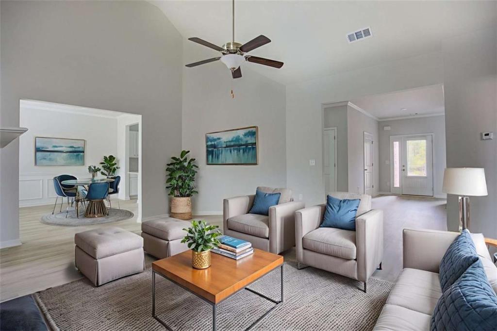1007 Towne Circle Social Circle, GA 30025 - Photo 10 of 38 a living room with furniture a rug and a lamp