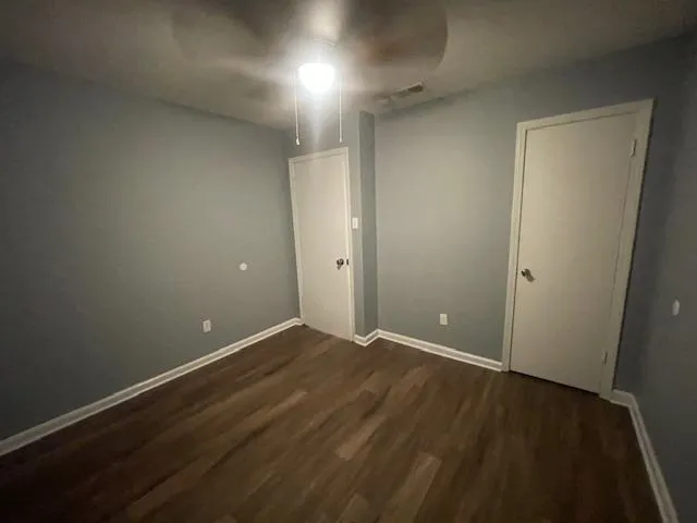 an empty room with wooden floor