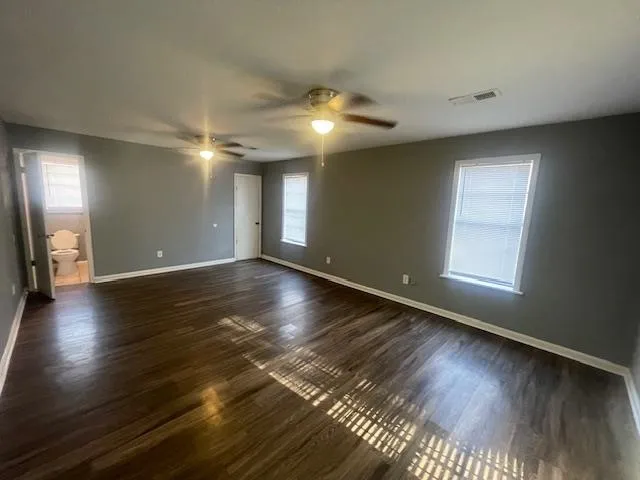 a view of room and hall with wooden floor