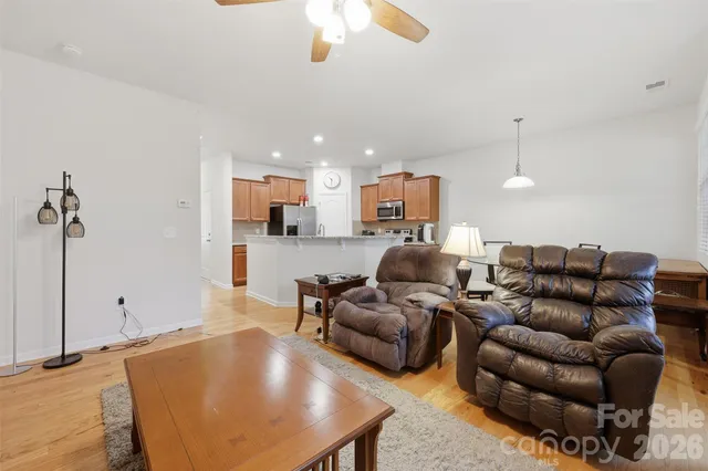 a living room with furniture a ceiling fan and a rug