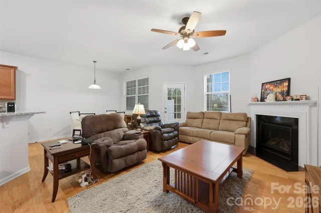 a living room with furniture ceiling fan and a fireplace
