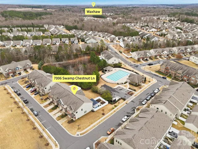 an aerial view of a house with a mountain