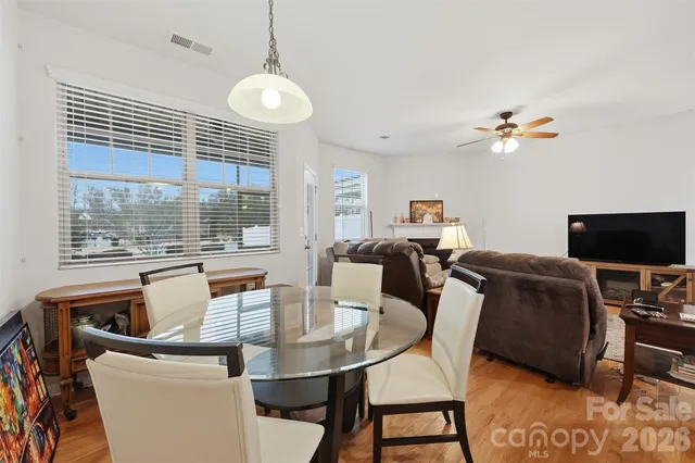 a living room with furniture a flat screen tv and a large window
