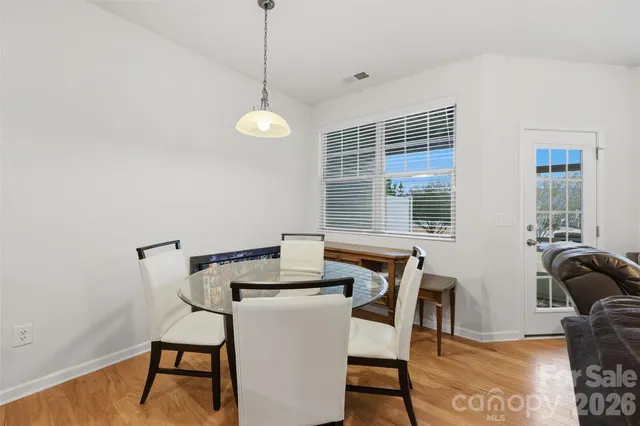 a view of a dining room with furniture and window