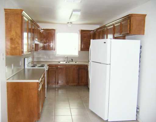 309 Easy Street, Unit A Corpus Christi, TX 78418 - Photo 4 of 8 a kitchen with a sink a refrigerator and a stove