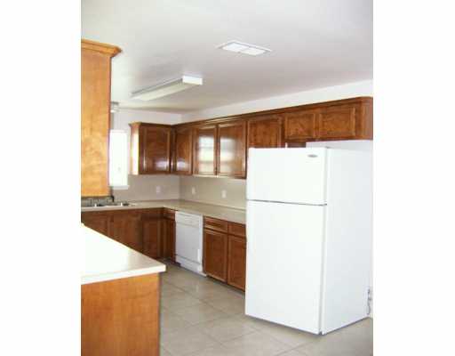 309 Easy Street, Unit A Corpus Christi, TX 78418 - Photo 5 of 8 a kitchen with a refrigerator a sink and dishwasher