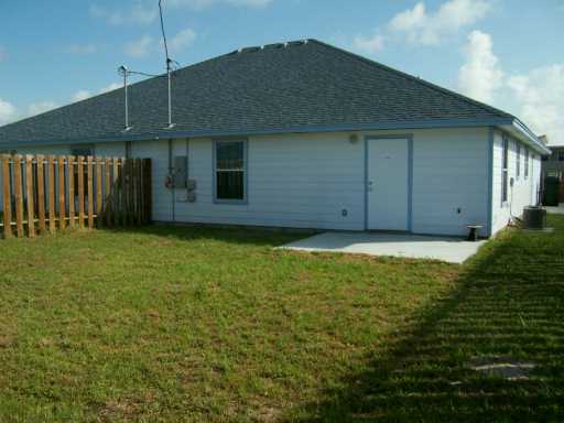 309 Easy Street, Unit A Corpus Christi, TX 78418 - Photo 6 of 8 a front view of a house with a garden