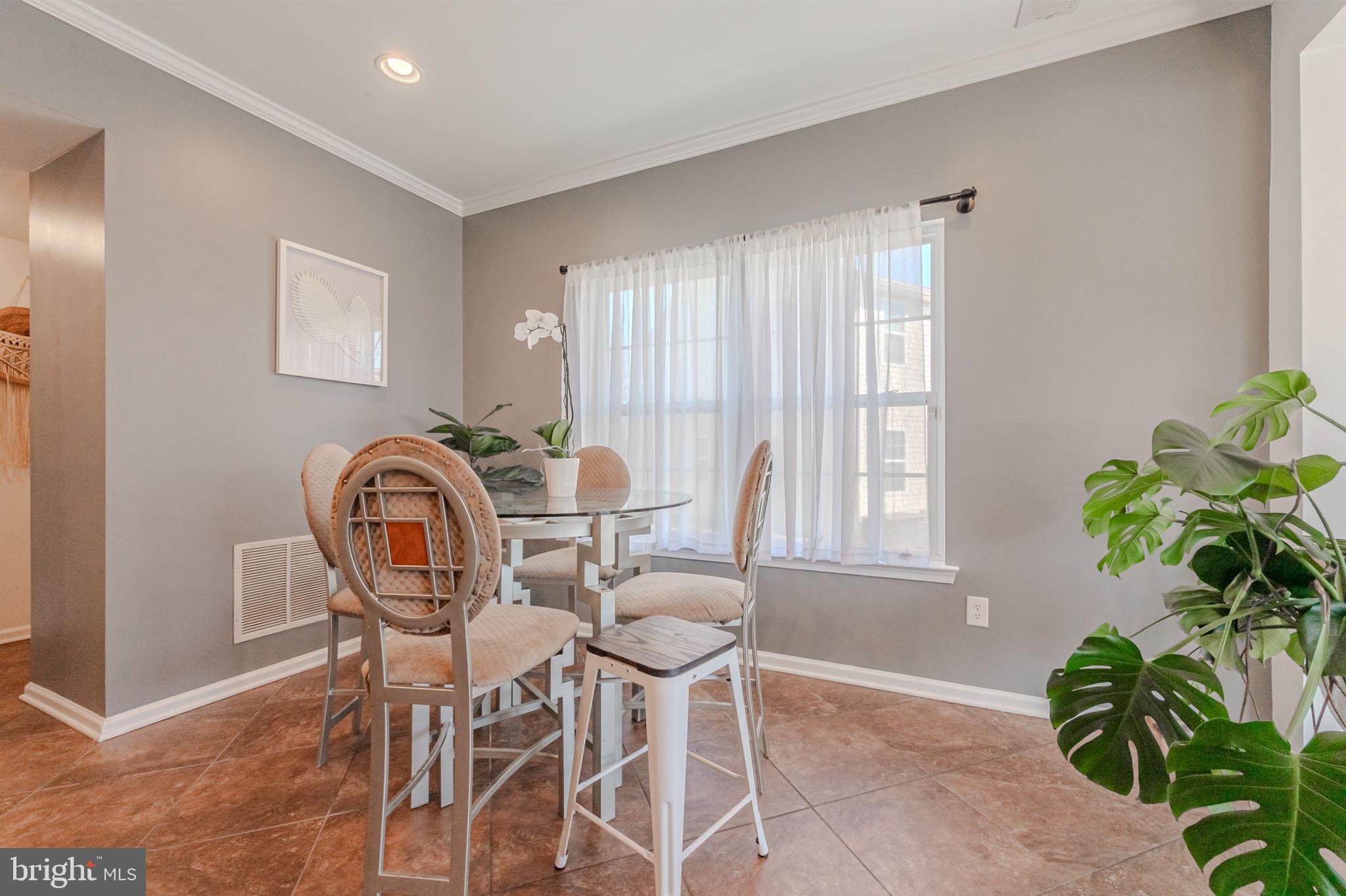 216 Alloway Place Townsend, DE 19734 - Photo 11 of 40 a view of a dining room with furniture and a potted plant