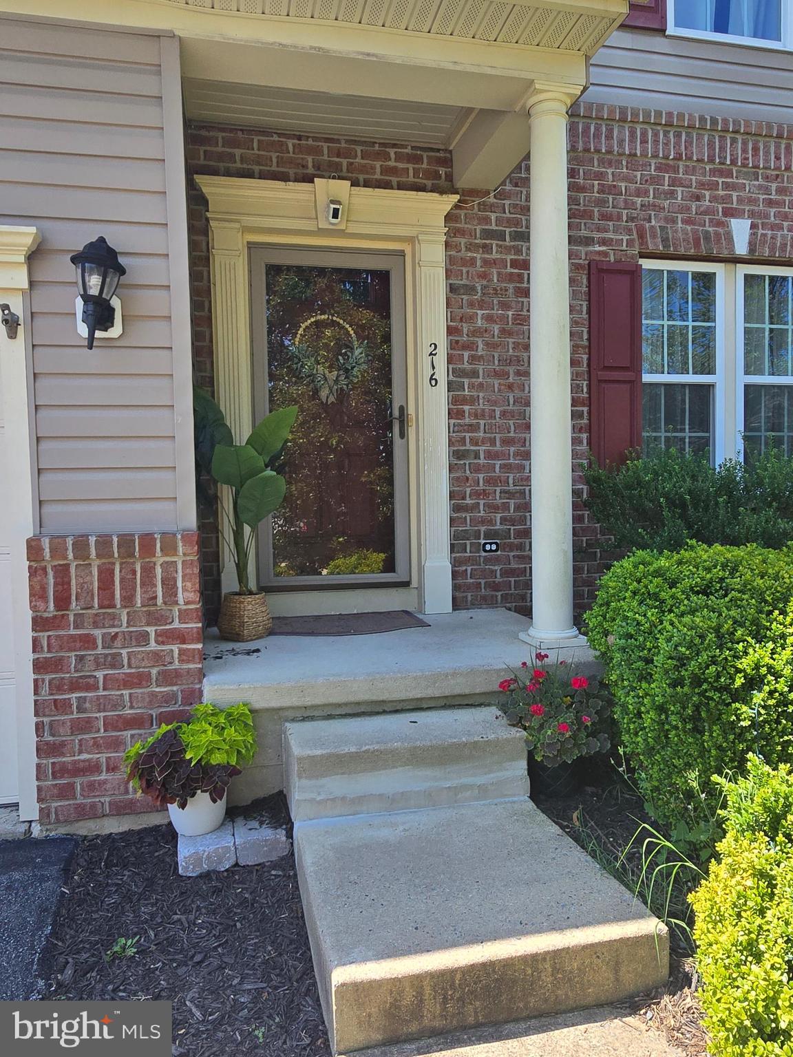 216 Alloway Place Townsend, DE 19734 - Photo 2 of 40 a front view of a house with potted plants