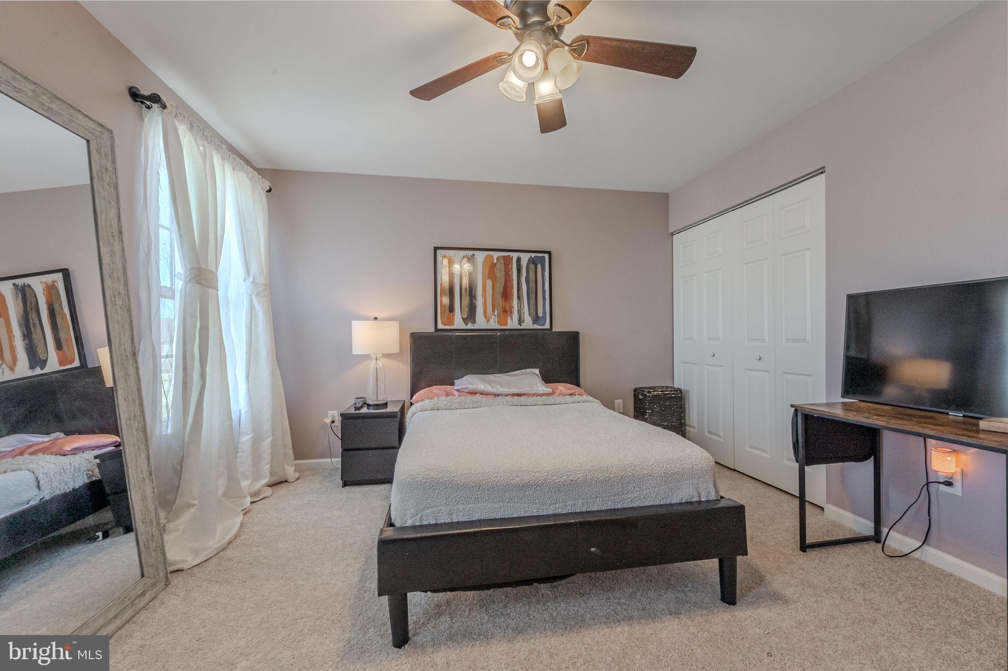 216 Alloway Place Townsend, DE 19734 - Photo 24 of 40 a bedroom with a bed and a flat screen tv