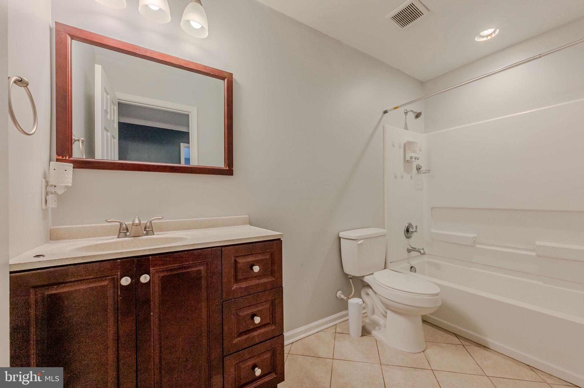 216 Alloway Place Townsend, DE 19734 - Photo 25 of 40 a bathroom with a granite countertop toilet sink and mirror