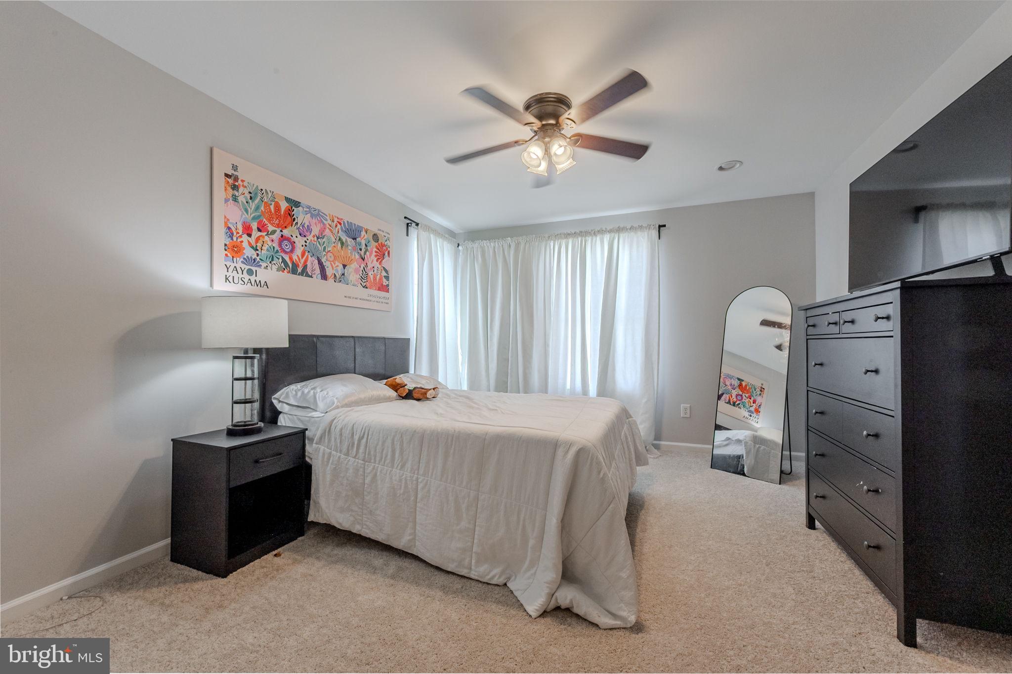 216 Alloway Place Townsend, DE 19734 - Photo 26 of 40 a bedroom with a bed and a chandelier