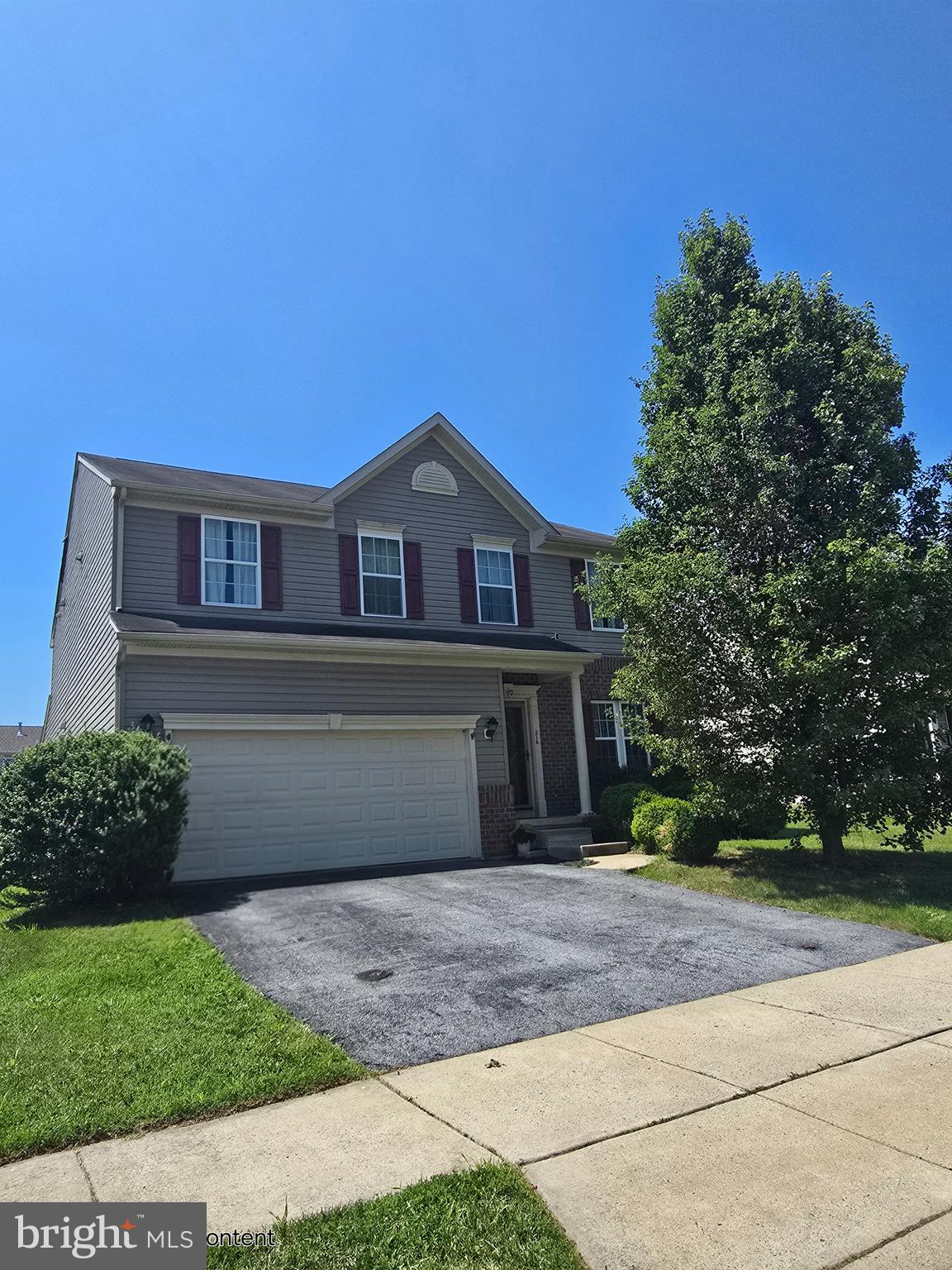 216 Alloway Place Townsend, DE 19734 - Photo 3 of 40 a front view of a house with a yard and garage