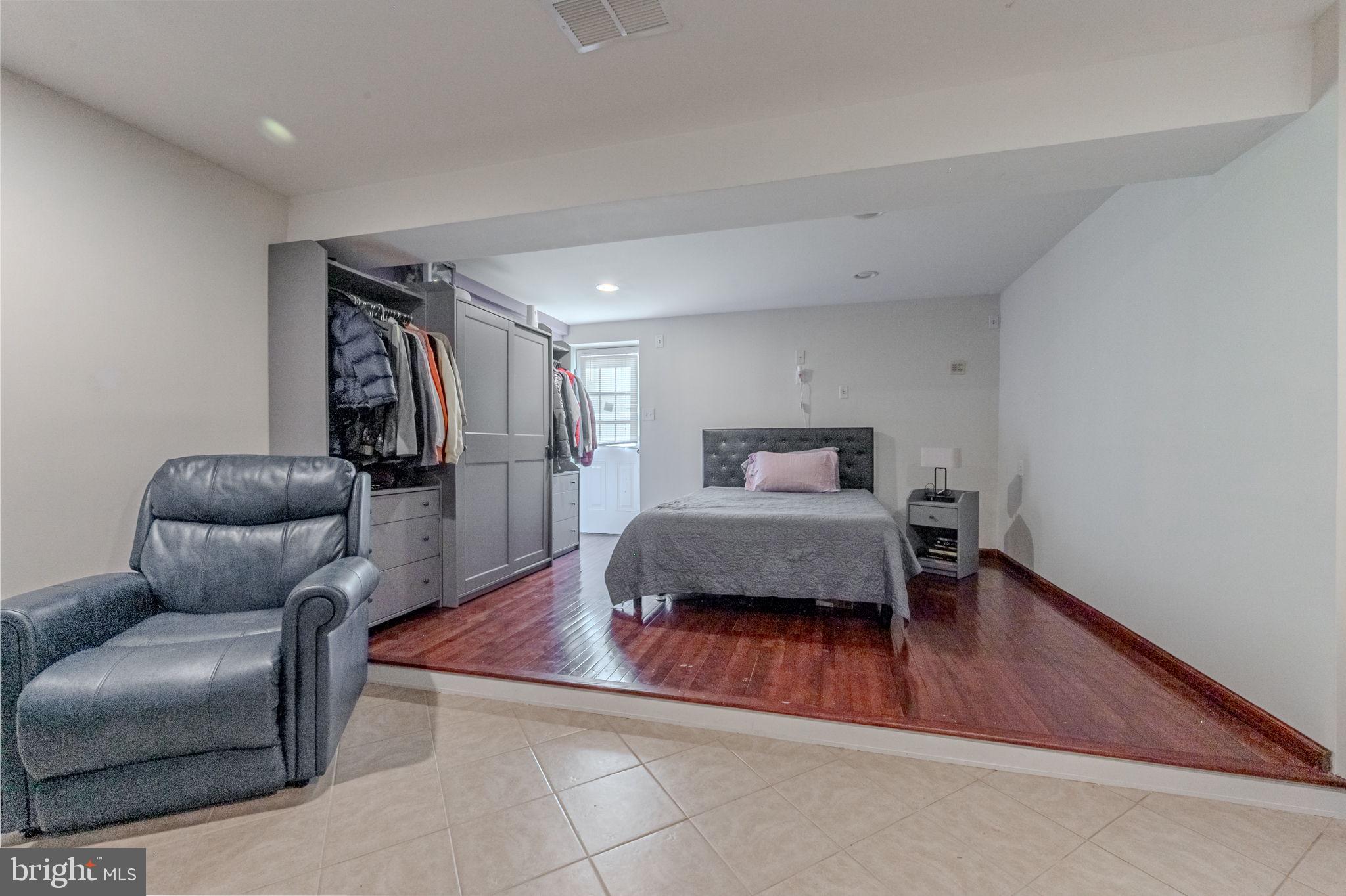 216 Alloway Place Townsend, DE 19734 - Photo 31 of 40 a bedroom with furniture and a wooden floor