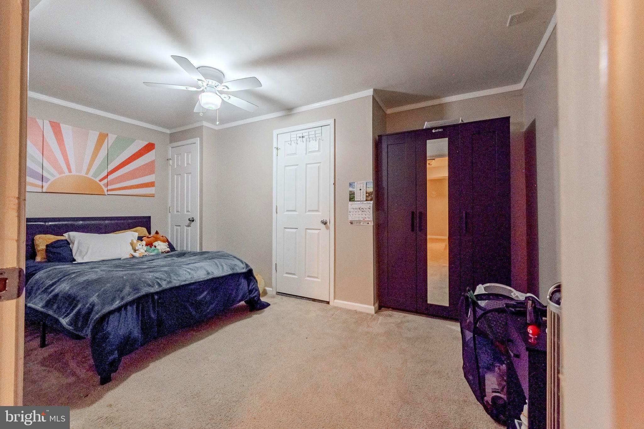 216 Alloway Place Townsend, DE 19734 - Photo 33 of 40 a bedroom with a bed and a chandelier