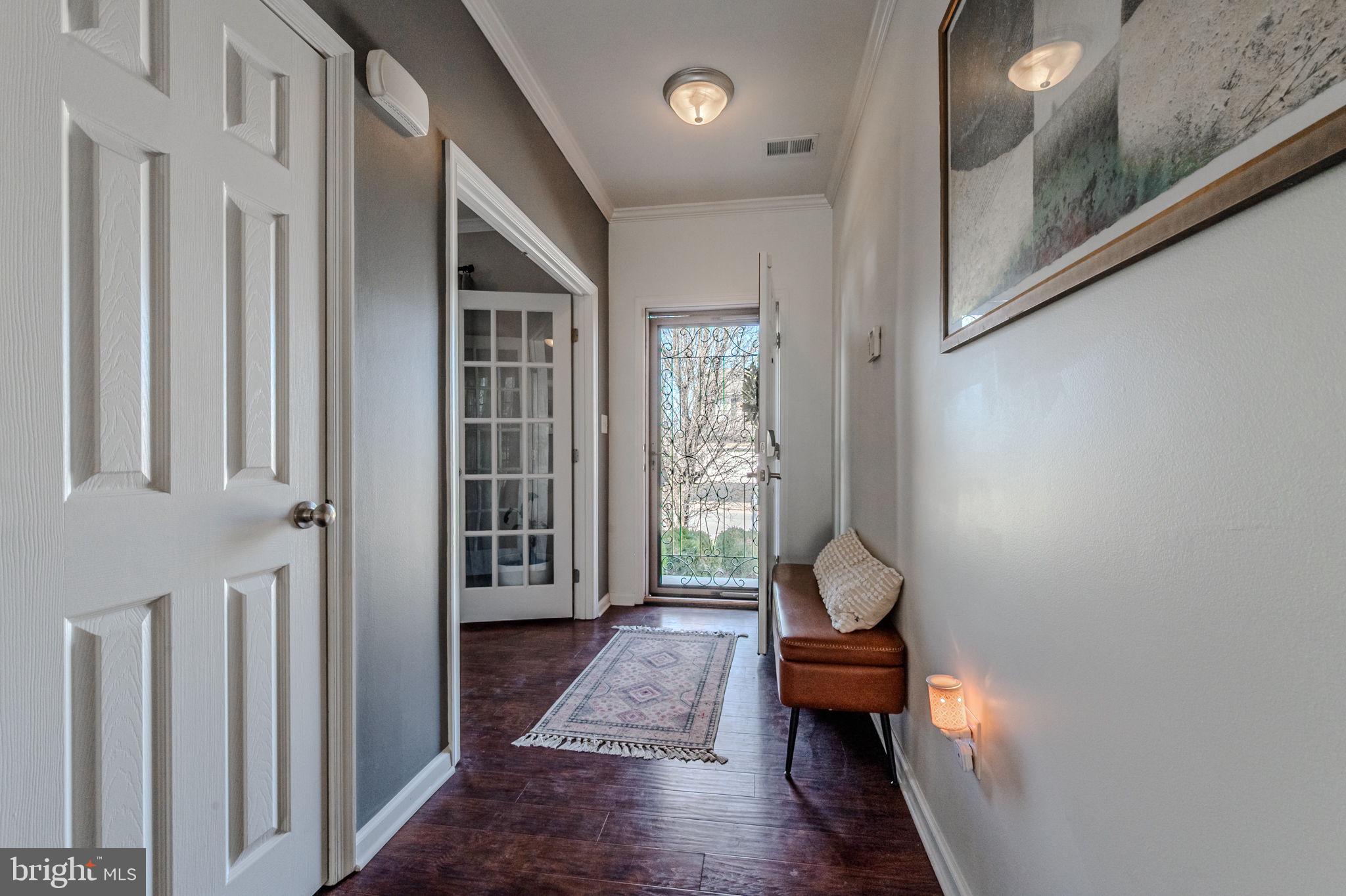 216 Alloway Place Townsend, DE 19734 - Photo 4 of 40 a hallway with wooden floor and a stairs