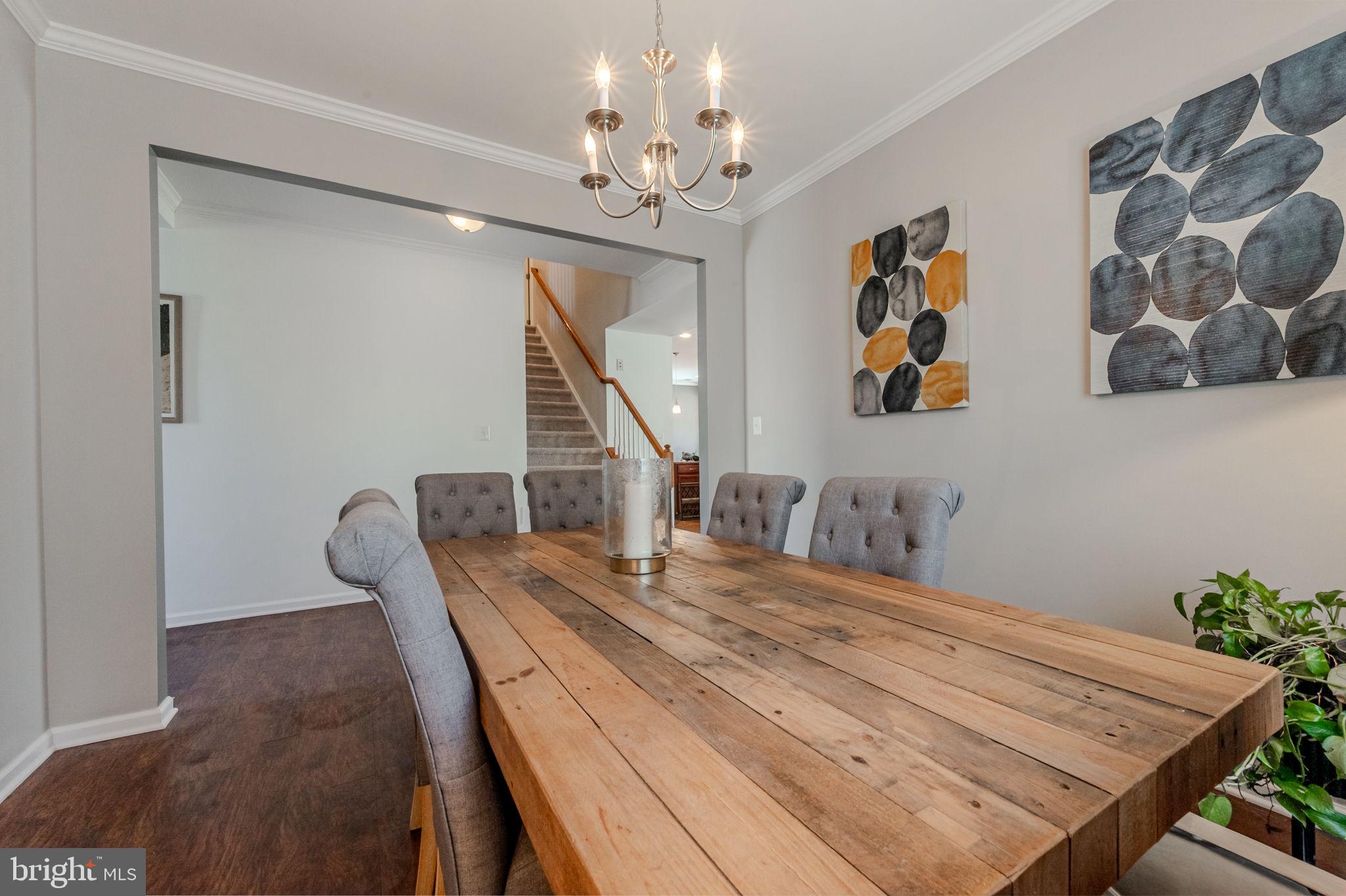 216 Alloway Place Townsend, DE 19734 - Photo 7 of 40 a dining room with wooden floor and chandelier