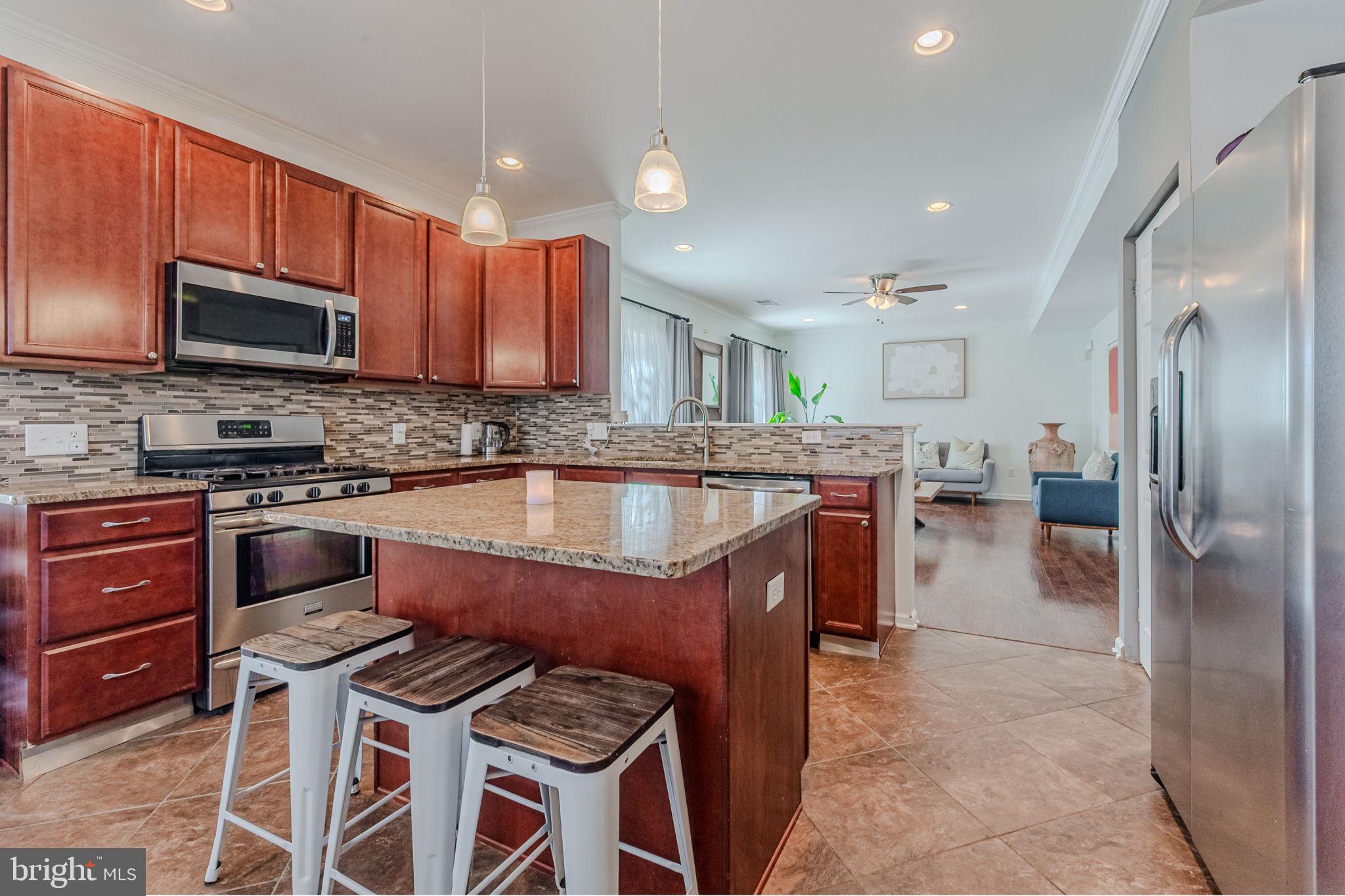 216 Alloway Place Townsend, DE 19734 - Photo 8 of 40 a kitchen with stainless steel appliances granite countertop a stove a sink dishwasher a refrigerator oven and a stove with wooden floor