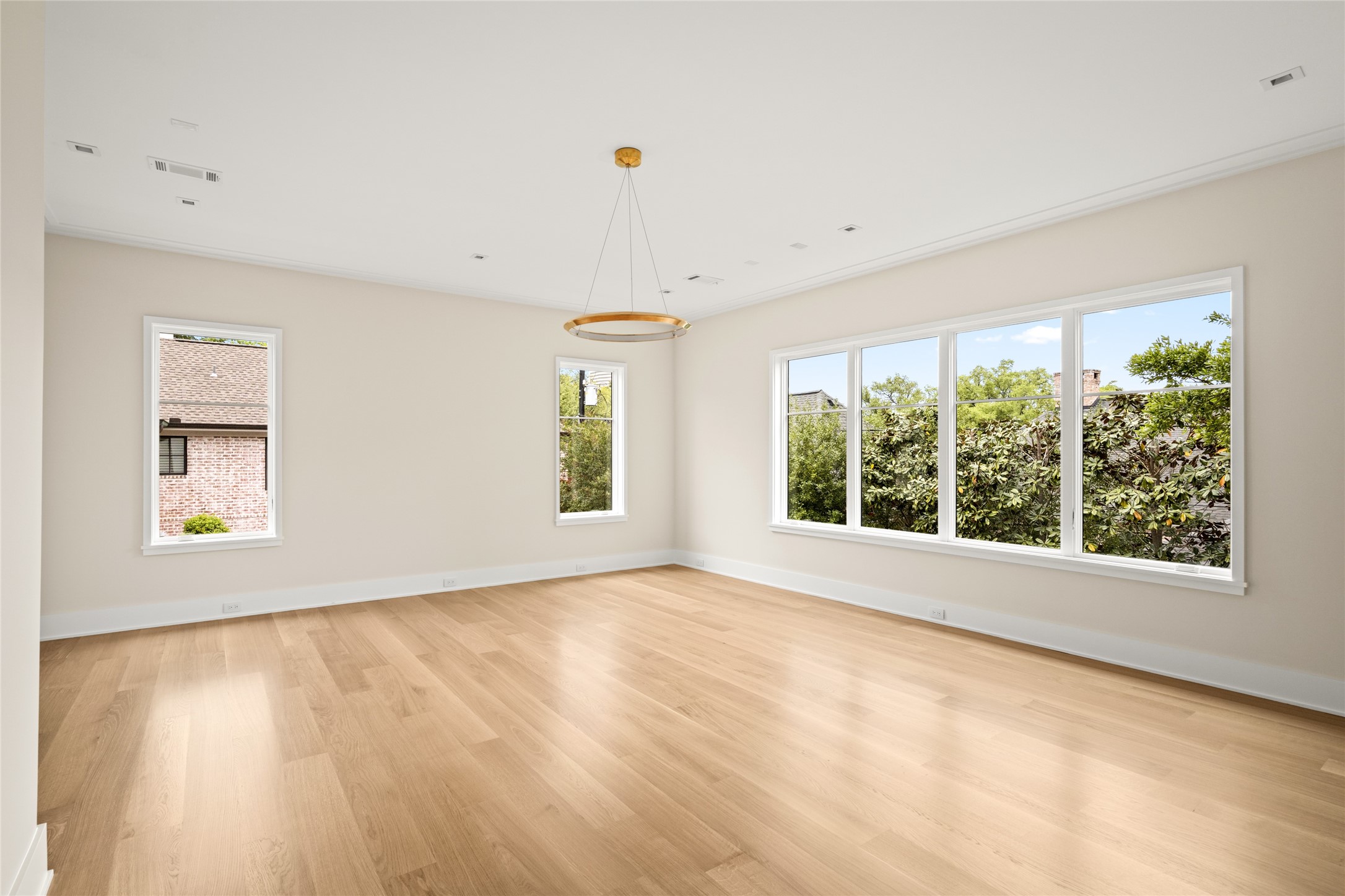 4006 Overbrook Lane Houston, TX 77027 - Photo 26 of 50 Expansive primary suite with oversized windows, abundant natural light, and a serene, private outlook.