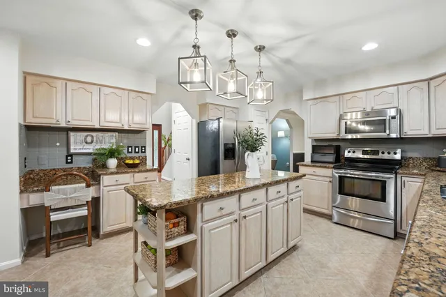 a kitchen with cabinets appliances and a counter top