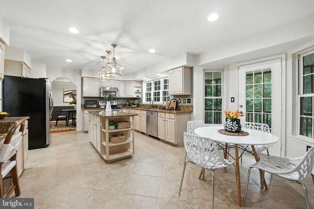 a kitchen with a stove a refrigerator and a dining table