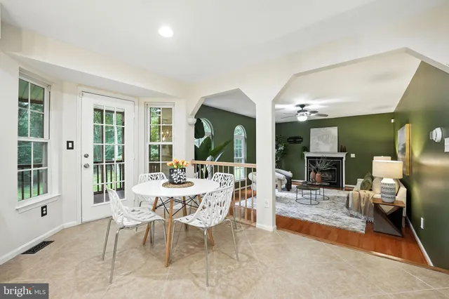 a living room with furniture a fireplace and a potted plant