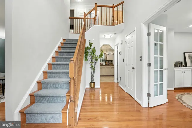 a view of entryway and hall with wooden floor