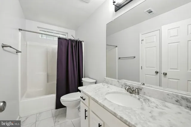 a view of hallway with wooden floor