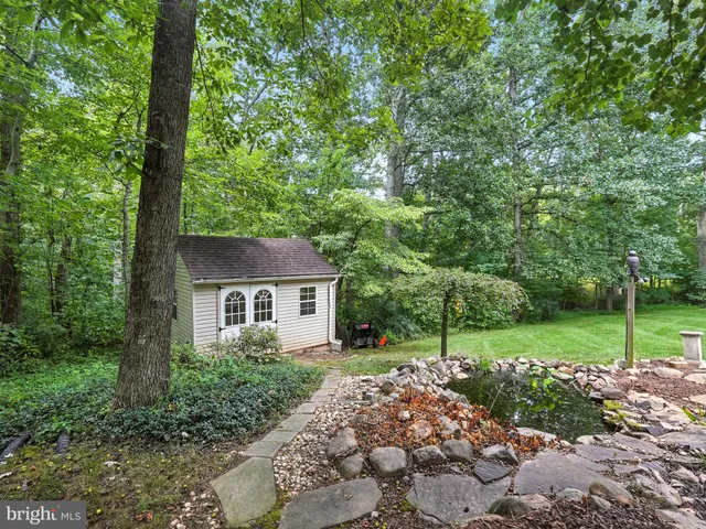 a view of a house with a yard porch and sitting area
