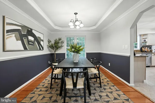 a view of a dining room with furniture and chandelier
