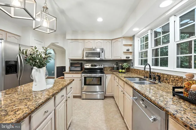 a kitchen with sink stove and microwave