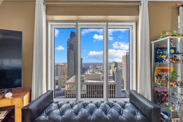 a living room with furniture and a floor to ceiling window