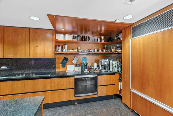 a kitchen with stainless steel appliances granite countertop a sink and cabinets