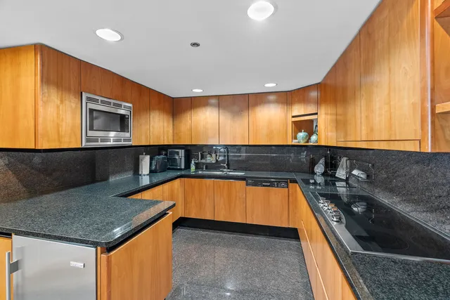 a view of a kitchen with a tub and chairs
