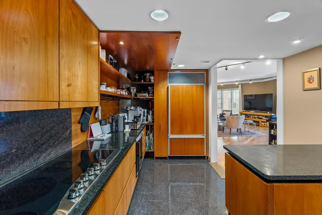 a kitchen with stainless steel appliances granite countertop a refrigerator and a stove