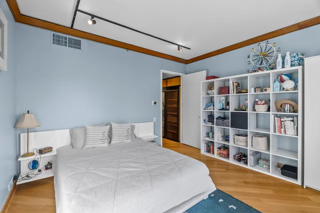 a bedroom with a bed and a book shelf
